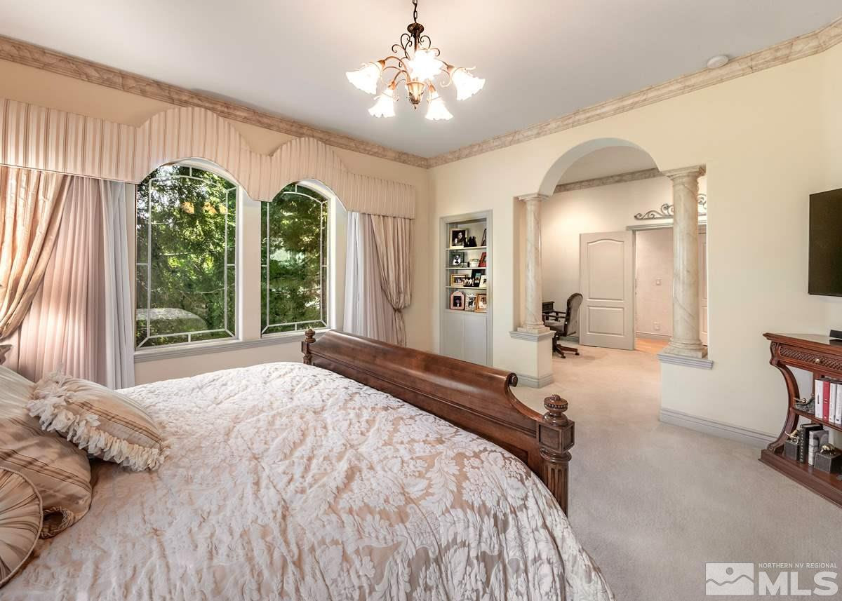 39 Sawbuck Road Reno, NV 89519 - Photo 9 of 23 a spacious bedroom with a large bed and a chandelier