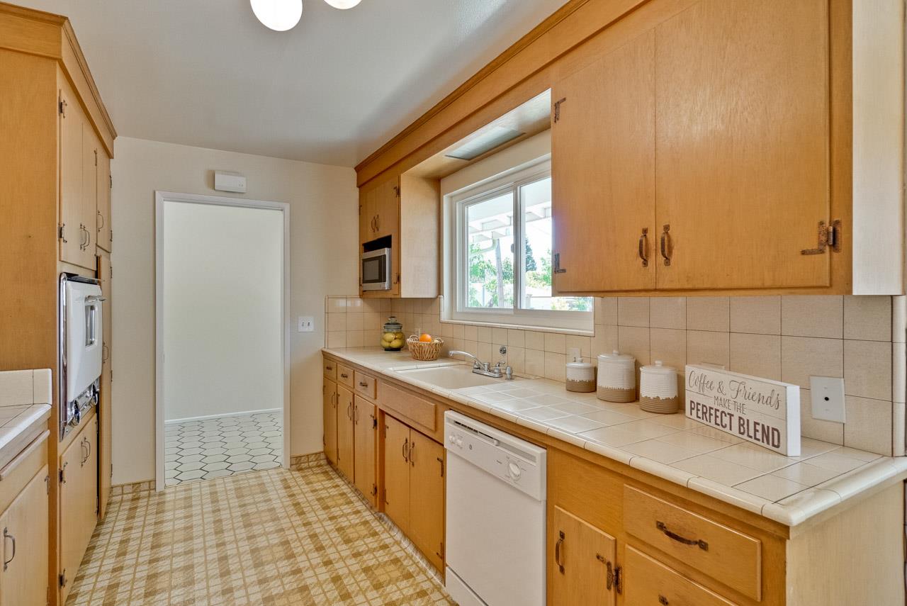 18665 Aspesi Drive Saratoga, CA 95070 - Photo 11 of 39 a kitchen with a sink and cabinets