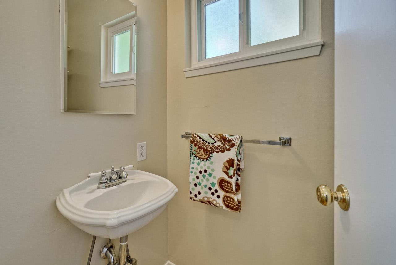 18665 Aspesi Drive Saratoga, CA 95070 - Photo 13 of 39 a bathroom with a sink and a mirror
