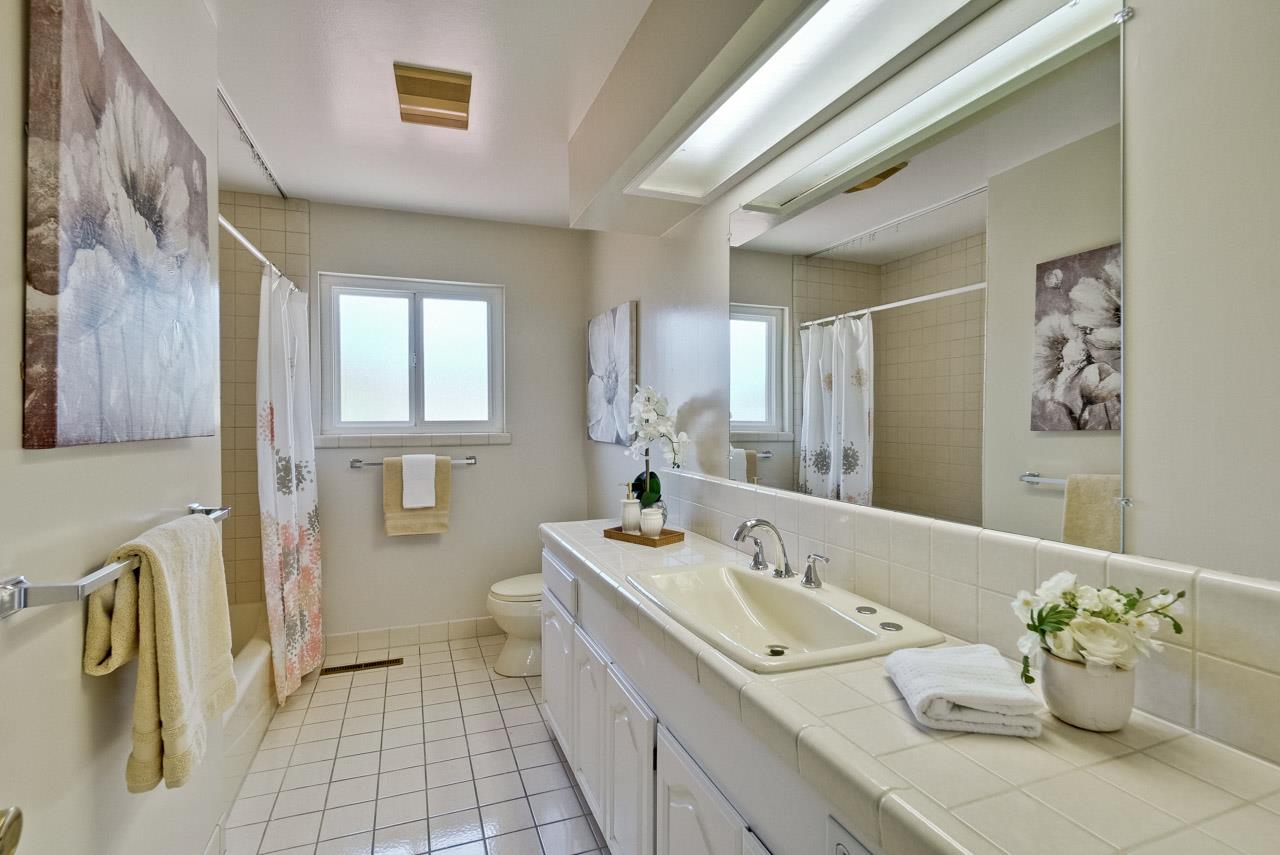 18665 Aspesi Drive Saratoga, CA 95070 - Photo 18 of 39 a bathroom with a sink mirror and a bath tub