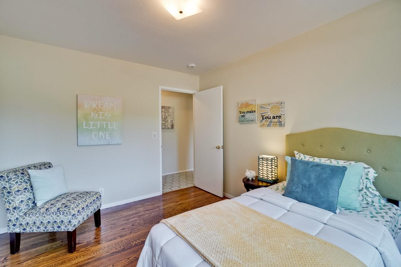 18665 Aspesi Drive Saratoga, CA 95070 - Photo 21 of 39 a bedroom with a bed and wooden floor