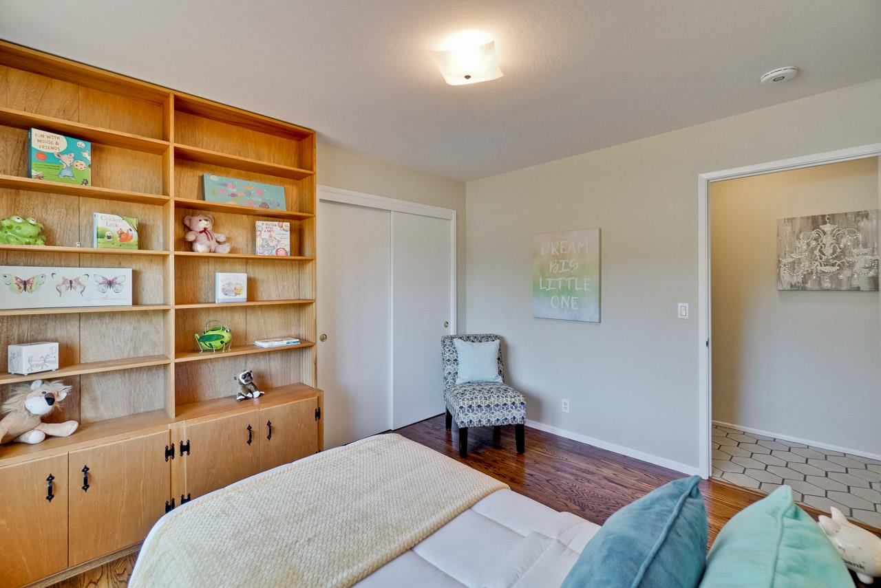 18665 Aspesi Drive Saratoga, CA 95070 - Photo 22 of 39 a room with a workspace and a bookshelf