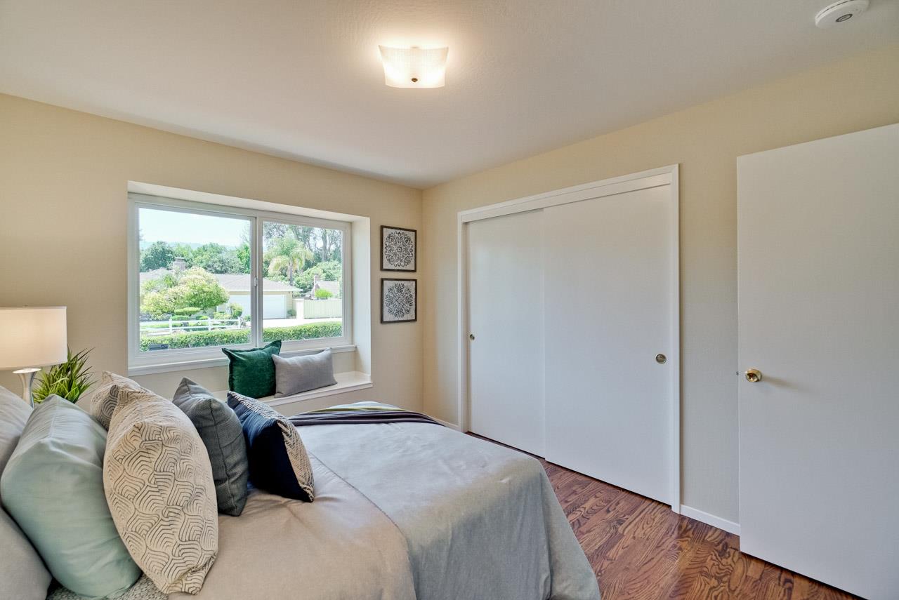 18665 Aspesi Drive Saratoga, CA 95070 - Photo 24 of 39 a bedroom with a bed and glass windows