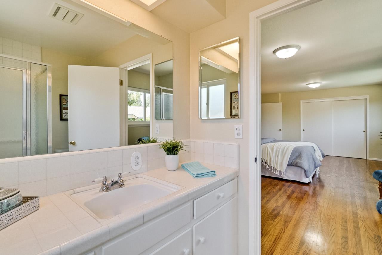 18665 Aspesi Drive Saratoga, CA 95070 - Photo 26 of 39 a en suite bathroom with a granite countertop tub sink and mirror
