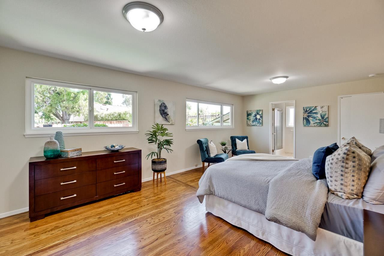 18665 Aspesi Drive Saratoga, CA 95070 - Photo 27 of 39 a bedroom with a bed and window with lamp