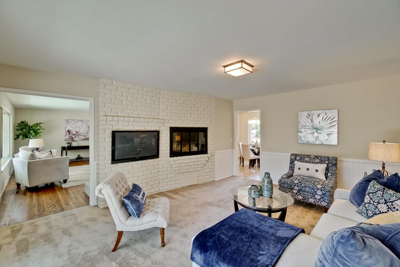 18665 Aspesi Drive Saratoga, CA 95070 - Photo 32 of 39 a living room with furniture and a flat screen tv
