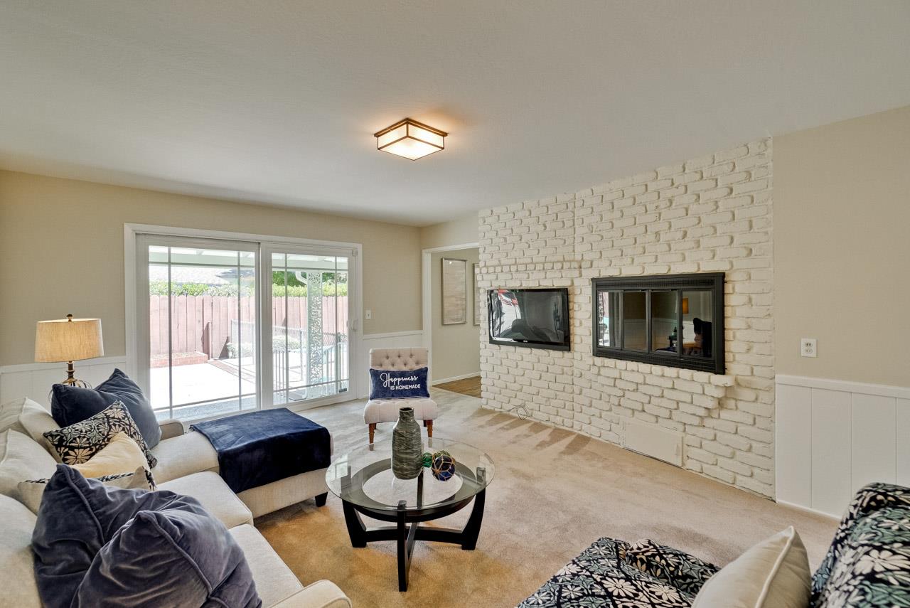 18665 Aspesi Drive Saratoga, CA 95070 - Photo 33 of 39 a living room with furniture or couch and a fireplace