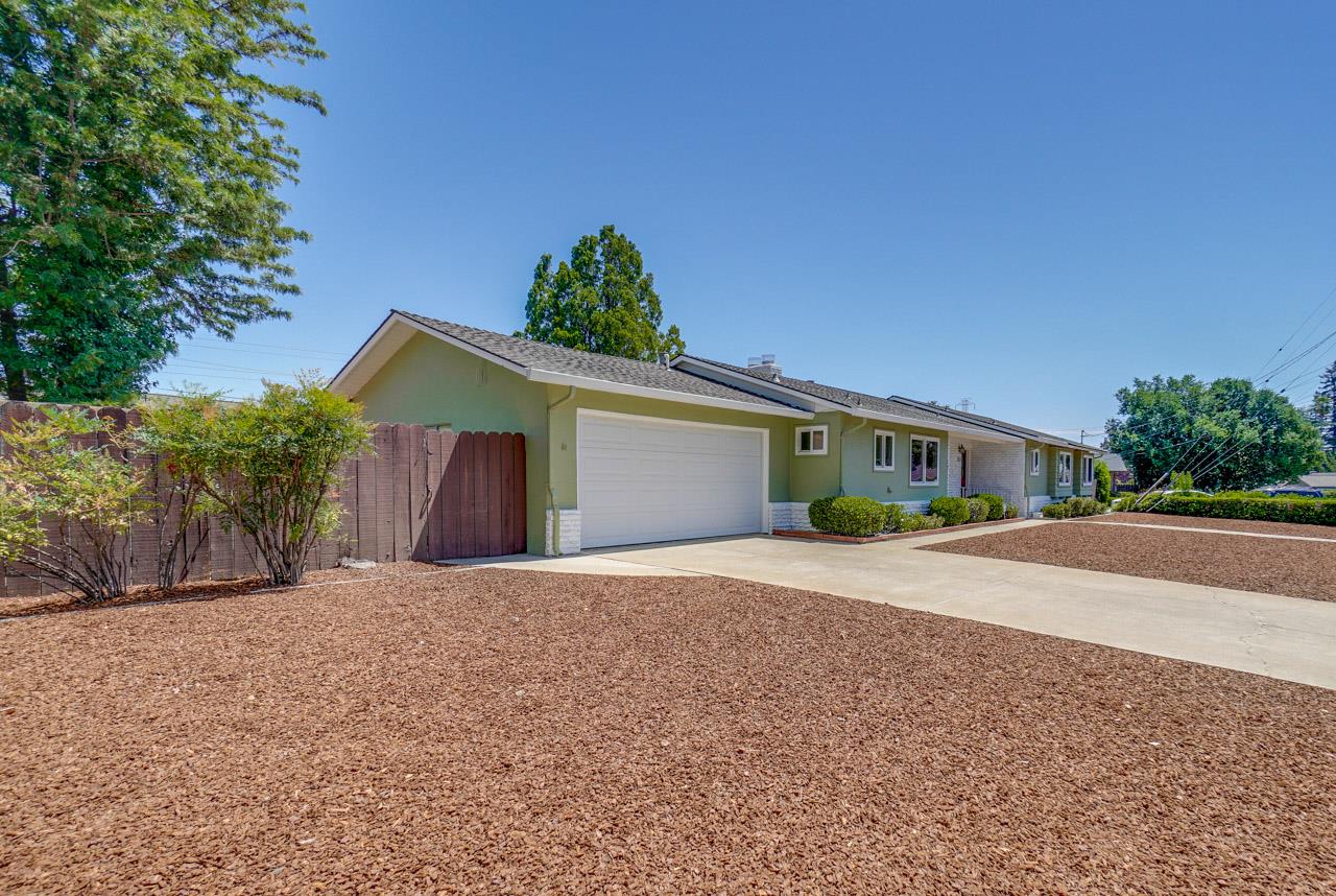 18665 Aspesi Drive Saratoga, CA 95070 - Photo 6 of 39 a front view of a house with a yard and garage