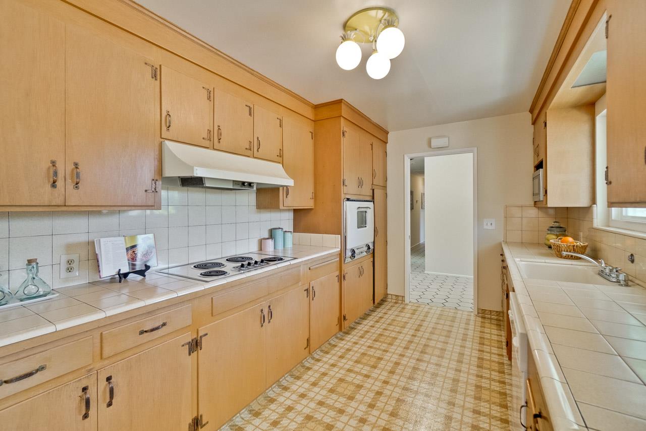 18665 Aspesi Drive Saratoga, CA 95070 - Photo 10 of 39 a kitchen with cabinets a sink and appliances