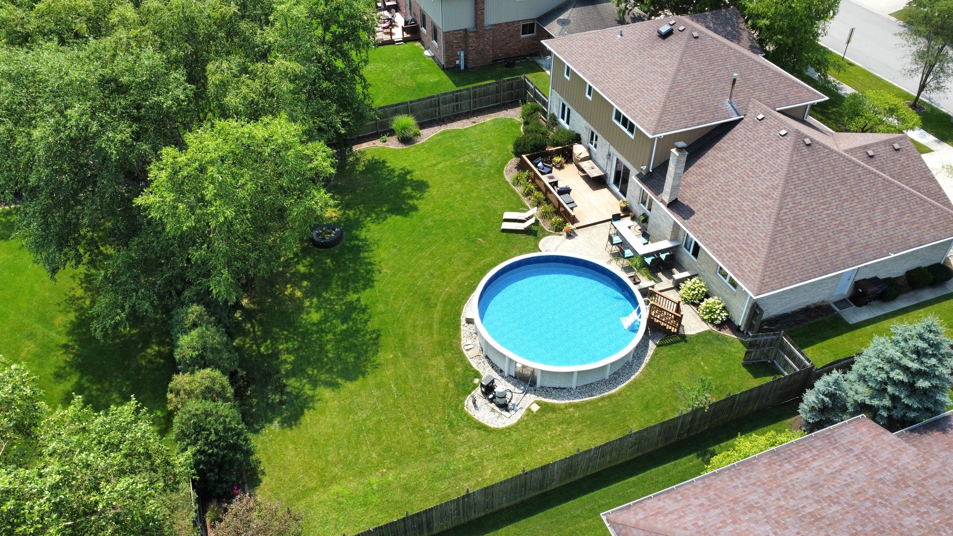 19451 Lancaster Drive Mokena, IL 60448 - Photo 2 of 32 an aerial view of a house roof deck with chairs and a swimming pool