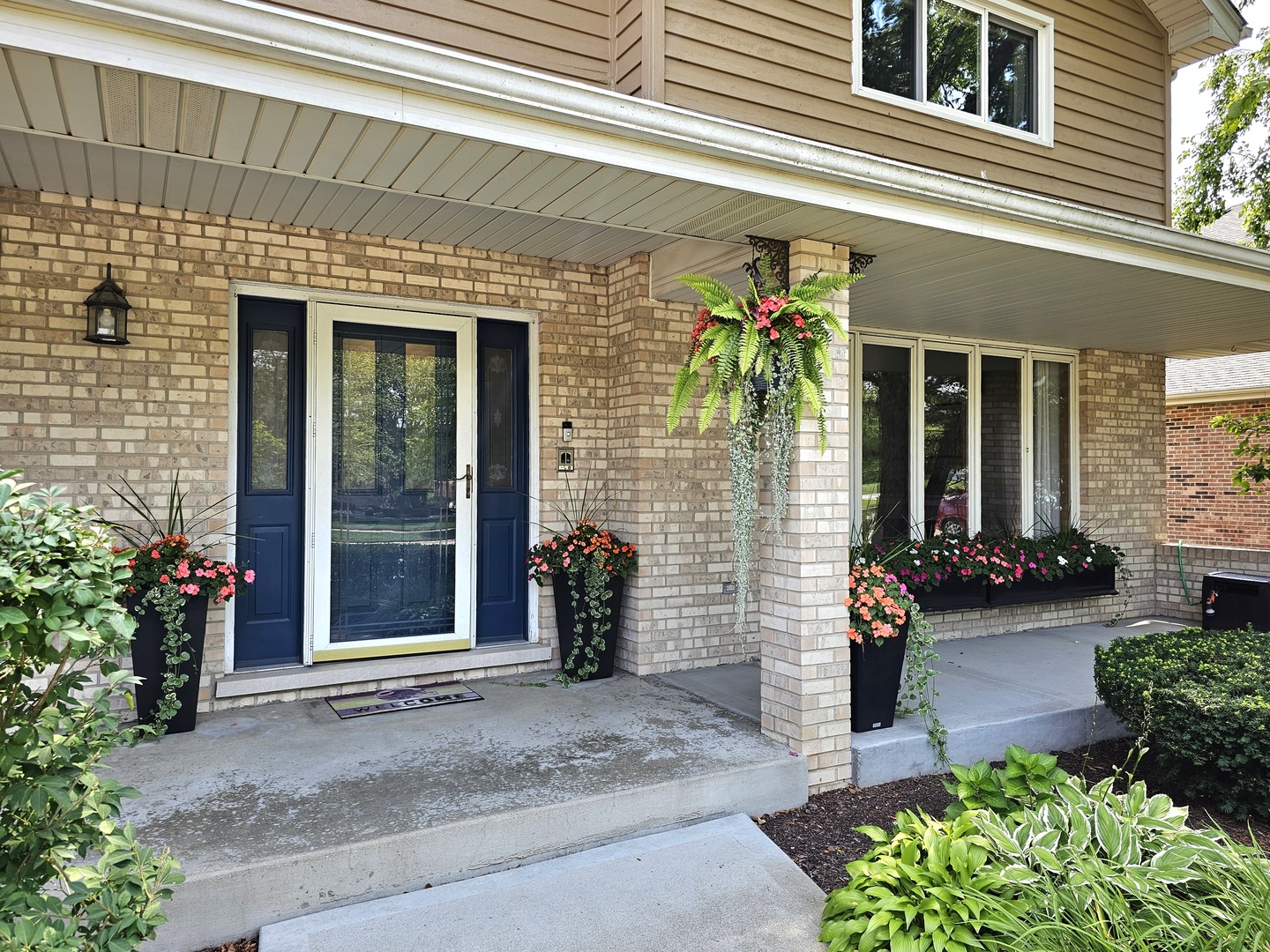 19451 Lancaster Drive Mokena, IL 60448 - Photo 3 of 32 a view of a brick house with potted plants
