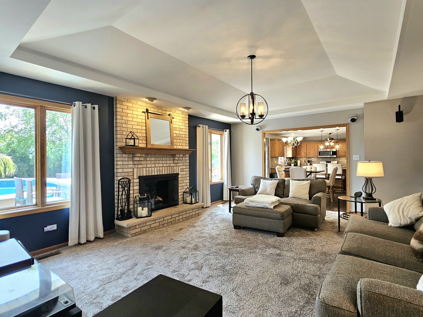 19451 Lancaster Drive Mokena, IL 60448 - Photo 9 of 32 a living room with furniture a fireplace and a chandelier