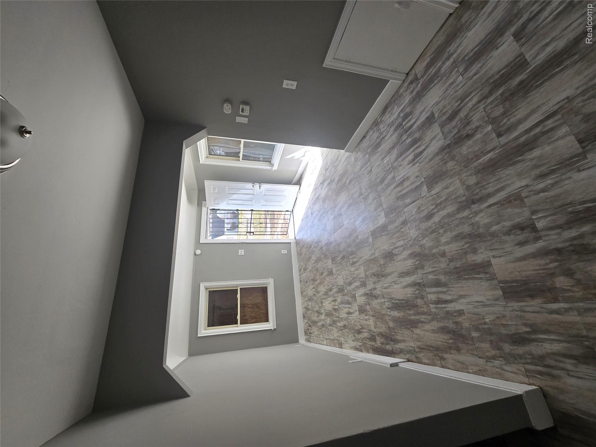 18119 Cornwall Street Detroit, MI 48224 - Photo 5 of 18 Unfurnished living room with dark wood-type flooring and arched walkways