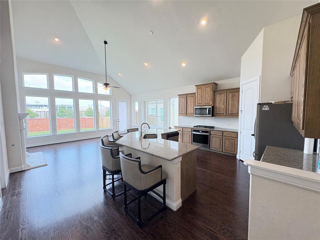 323 Butternut Way Irving, TX 75063 - Photo 9 of 32 a kitchen with a table chairs microwave and cabinets