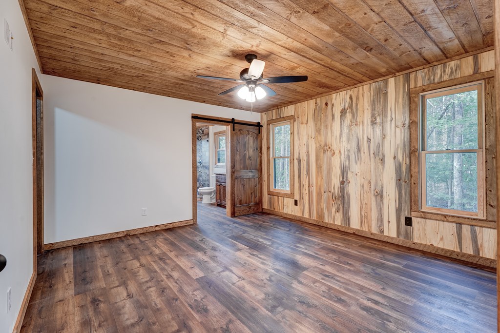 3448 Lickskillet Road Epworth, GA 30541 - Photo 13 of 71 a view of an empty room with wooden floor and a window
