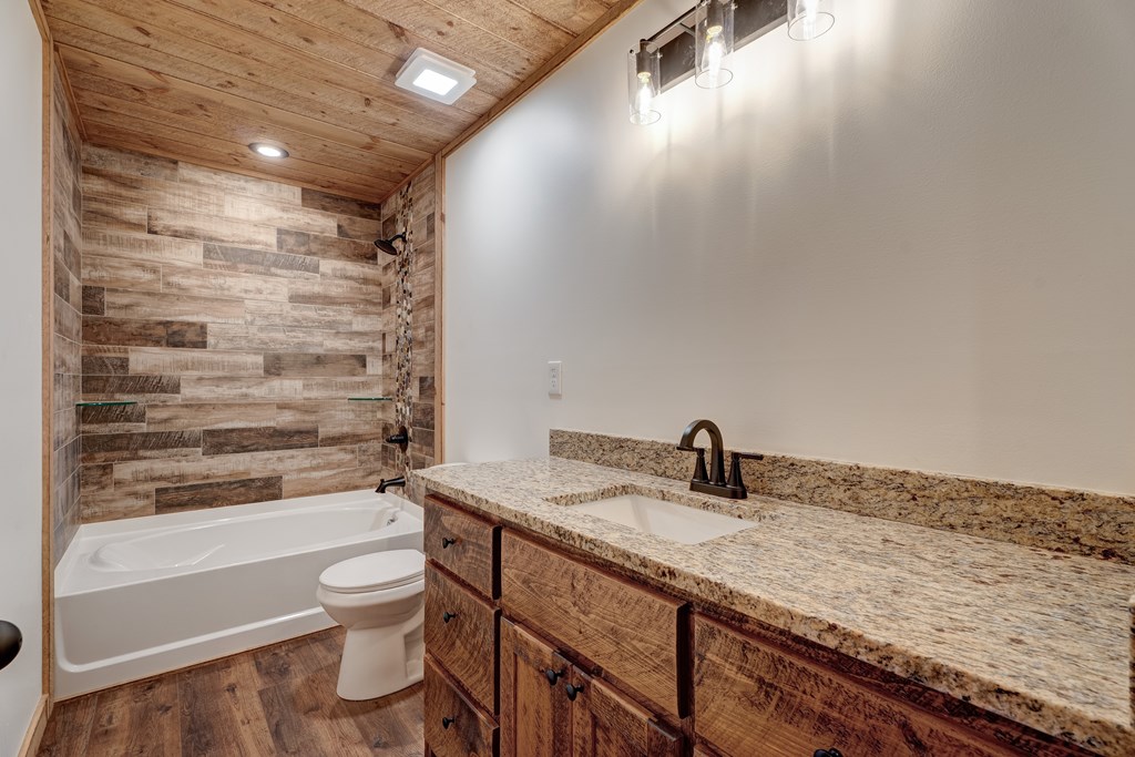 3448 Lickskillet Road Epworth, GA 30541 - Photo 22 of 71 a bathroom with a granite countertop sink toilet and shower