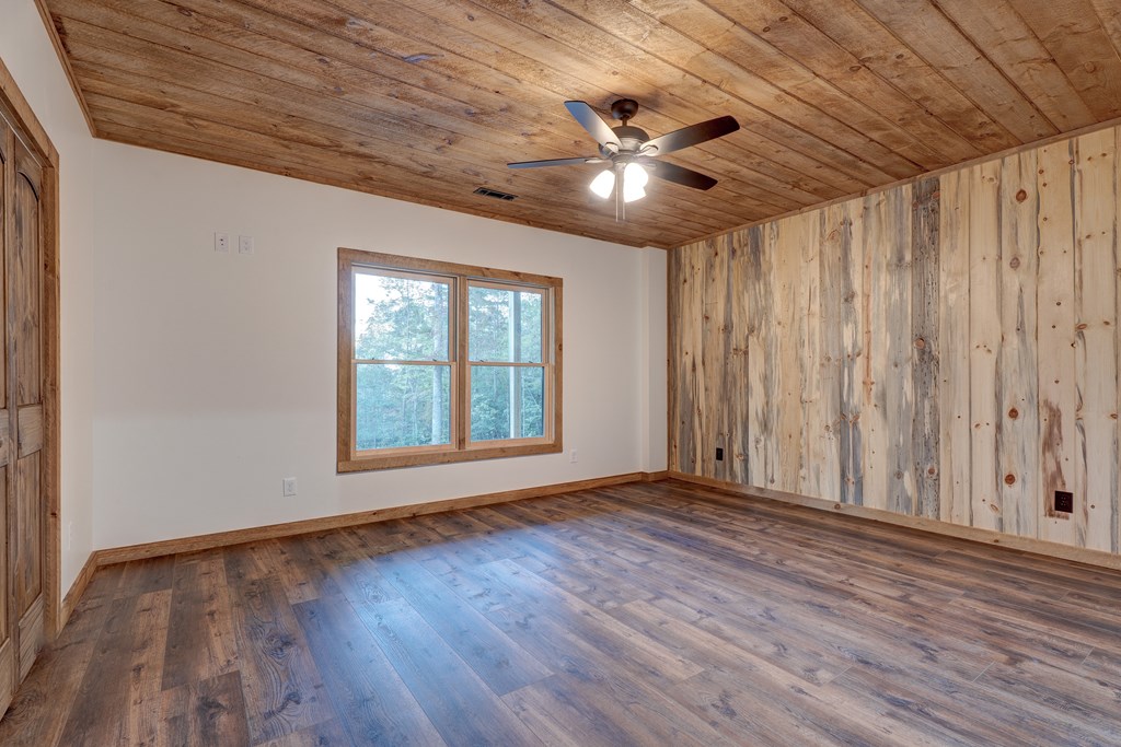 3448 Lickskillet Road Epworth, GA 30541 - Photo 41 of 71 a view of an empty room with wooden floor and a window