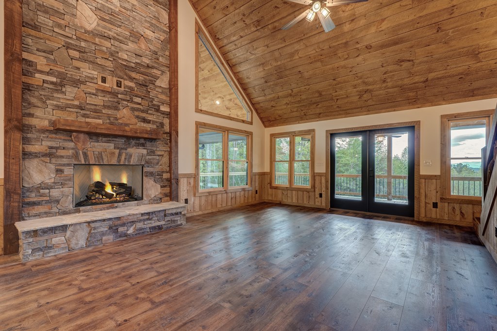 3448 Lickskillet Road Epworth, GA 30541 - Photo 7 of 71 a view of an empty room with wooden floor and a fireplace