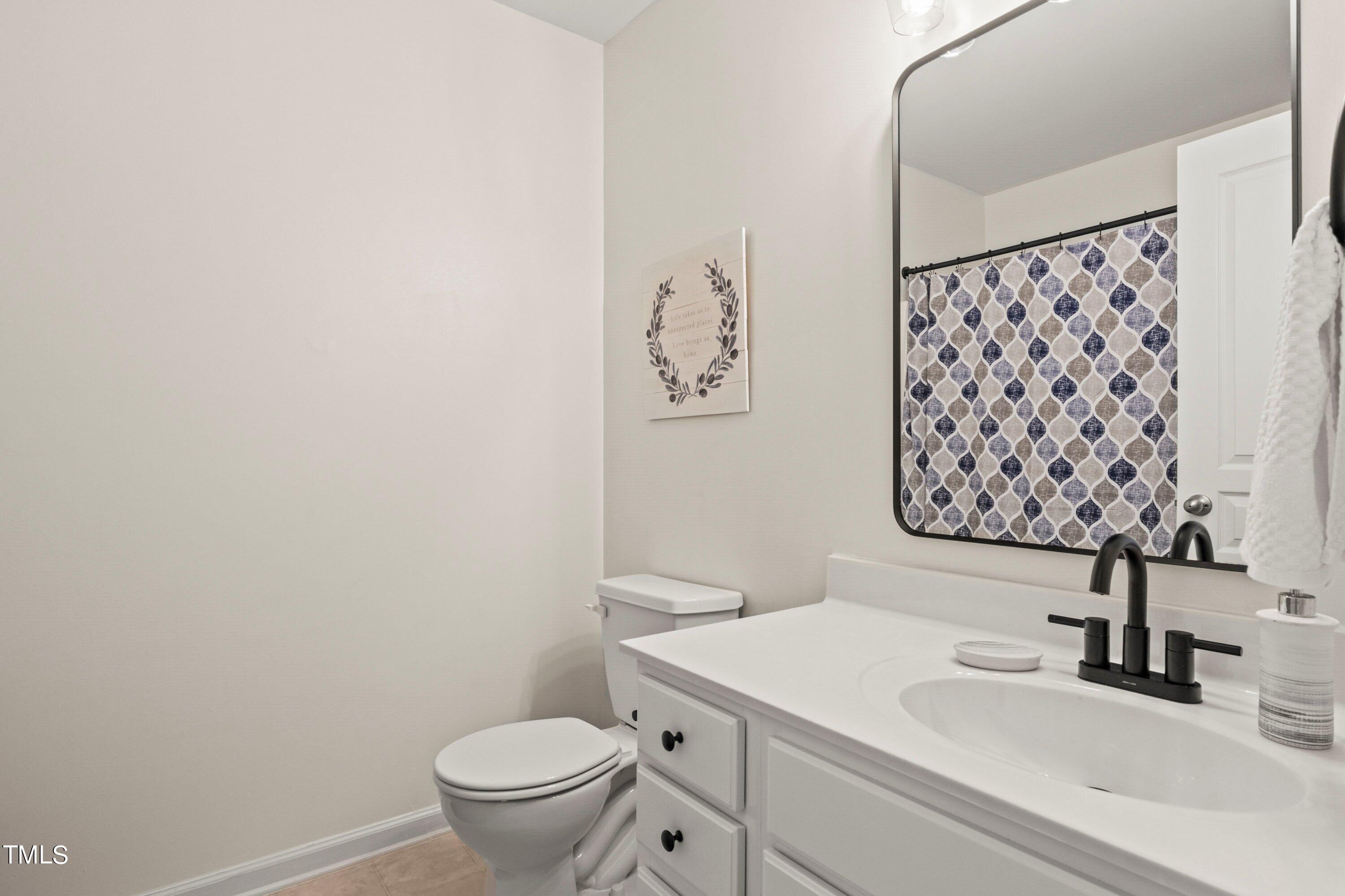 5476 Crescentview Parkway Raleigh, NC 27606 - Photo 23 of 36 Guest bath on 3rd level has updated plumbing fixture, mirror & light fixture.
