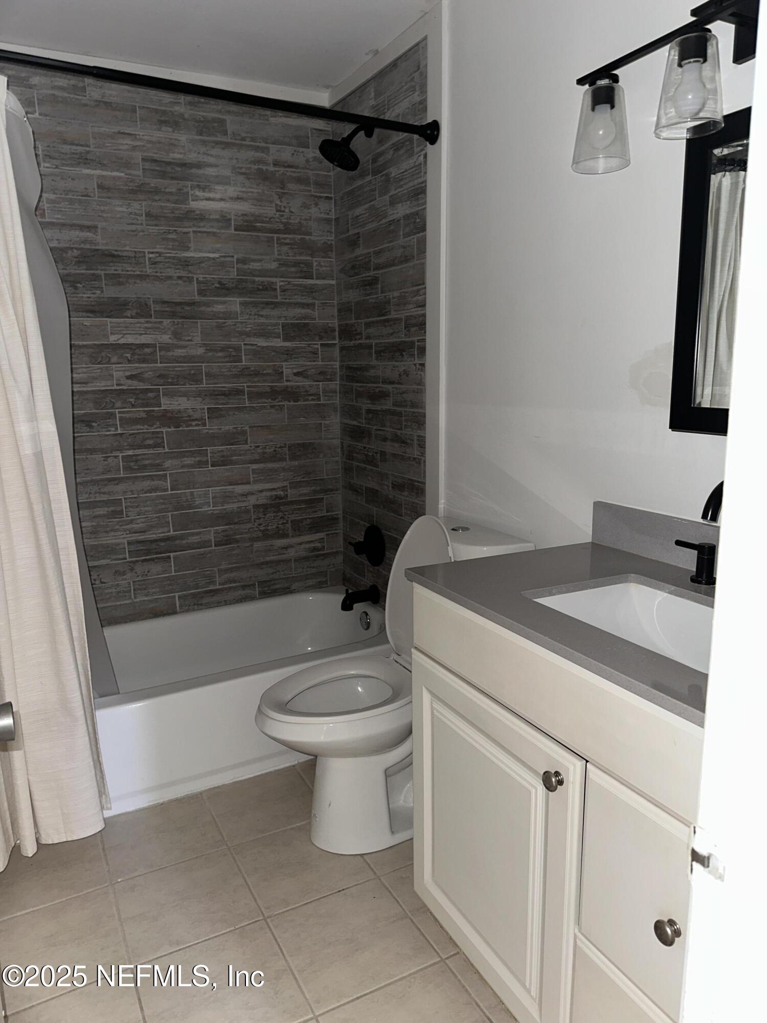 1756 El Prado Road, Unit 3 Jacksonville, FL 32216 - Photo 11 of 23 a bathroom with a shower toilet and sink