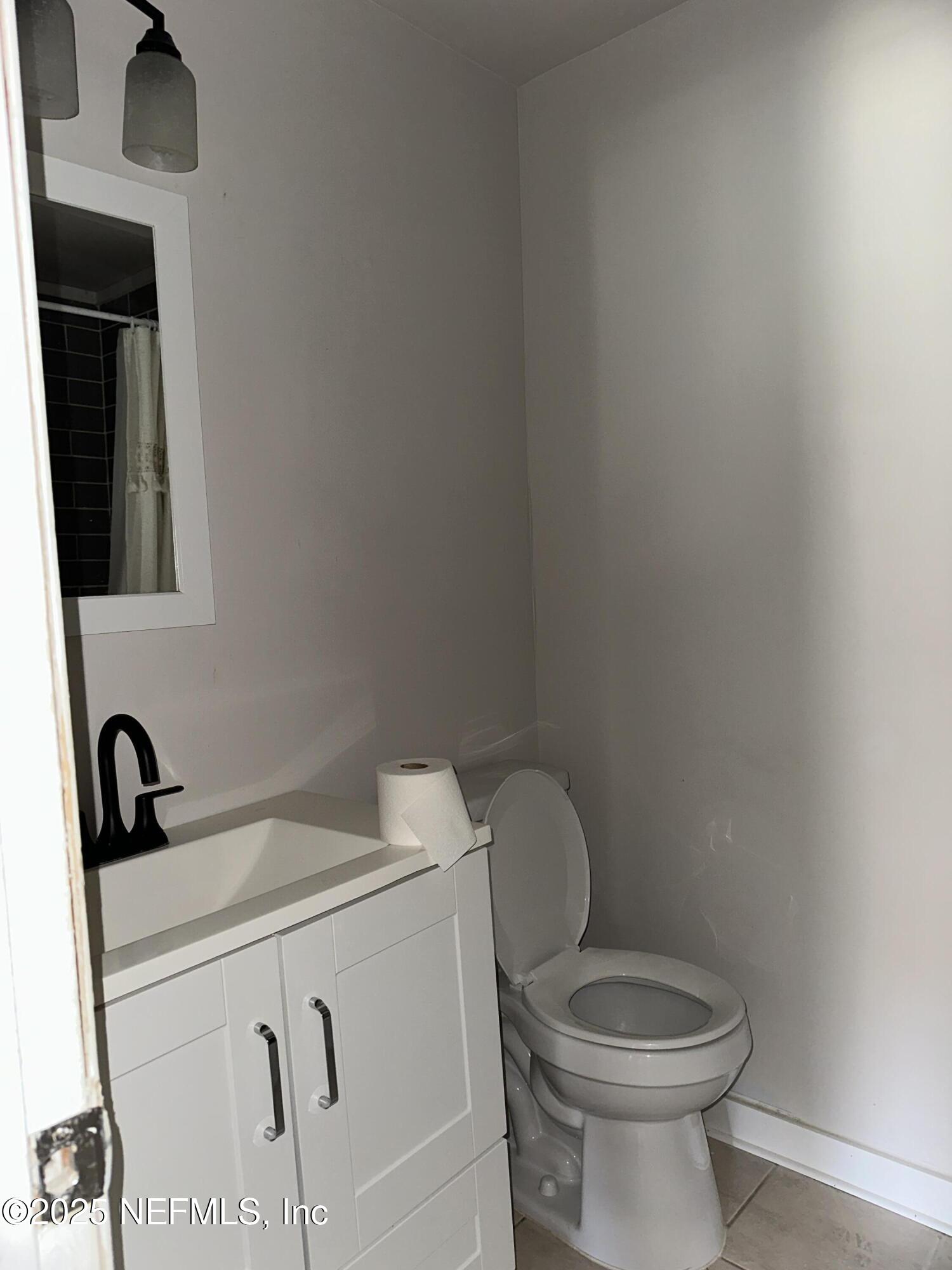 1756 El Prado Road, Unit 3 Jacksonville, FL 32216 - Photo 14 of 23 a bathroom with a toilet sink and mirror