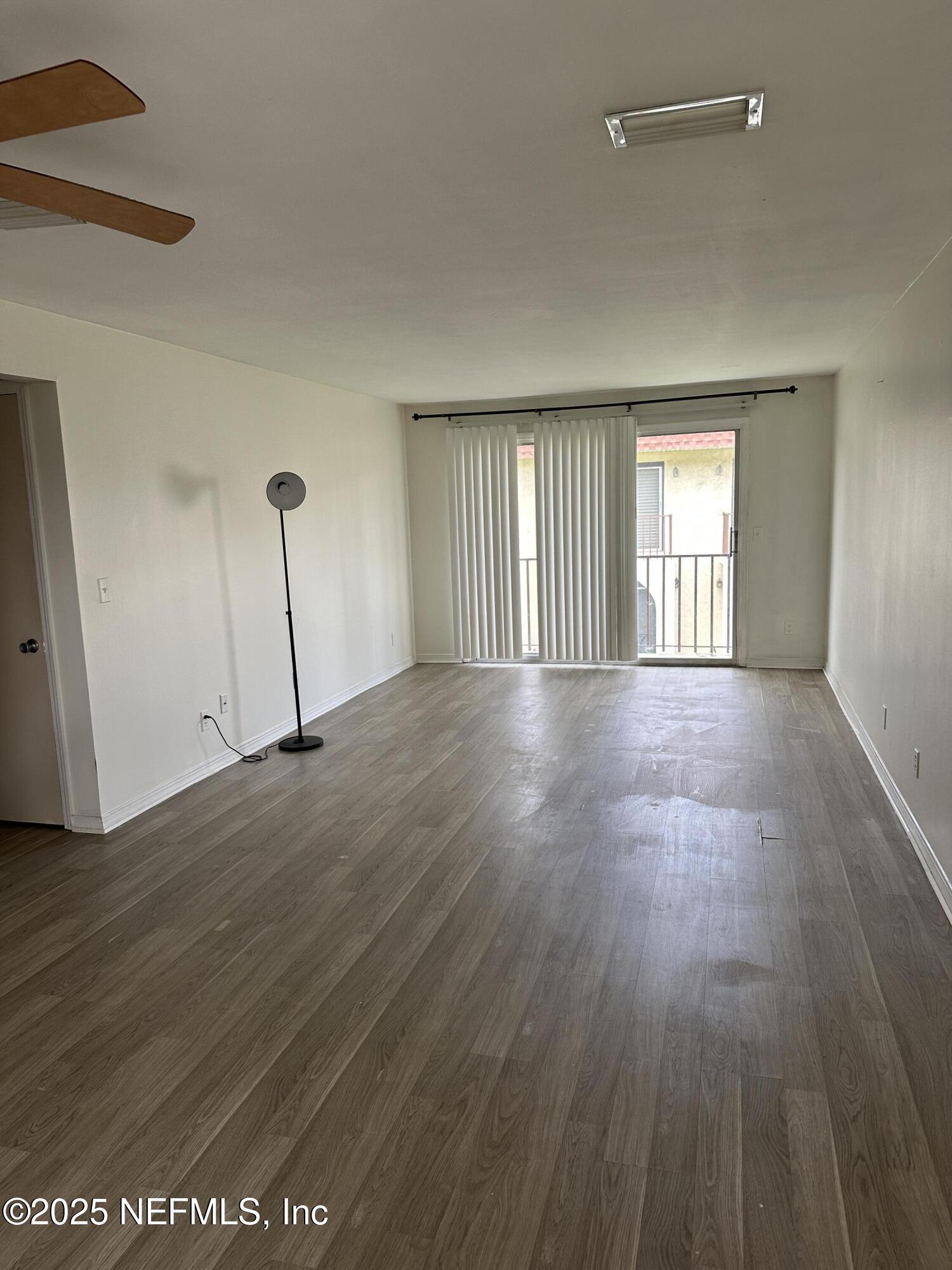 1756 El Prado Road, Unit 3 Jacksonville, FL 32216 - Photo 3 of 23 an empty room with wooden floor and windows