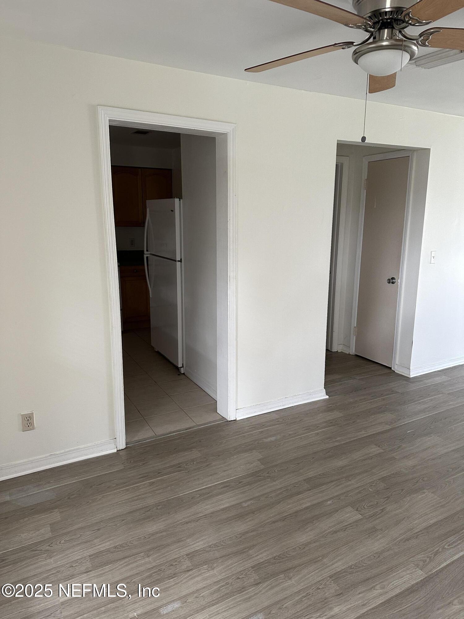 1756 El Prado Road, Unit 3 Jacksonville, FL 32216 - Photo 4 of 23 a view of a room with wooden floor and a ceiling fan