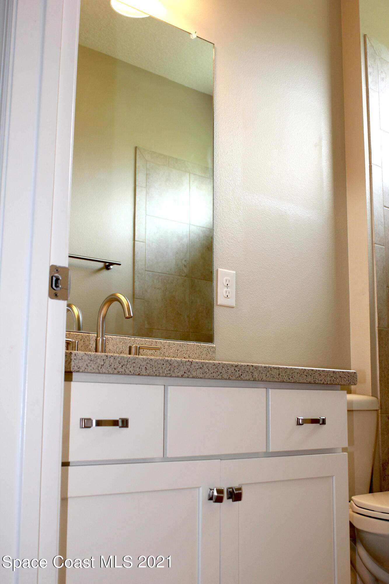 3630 Stabane Place Melbourne, FL 32940 - Photo 15 of 24 a bathroom with a granite countertop sink and a mirror