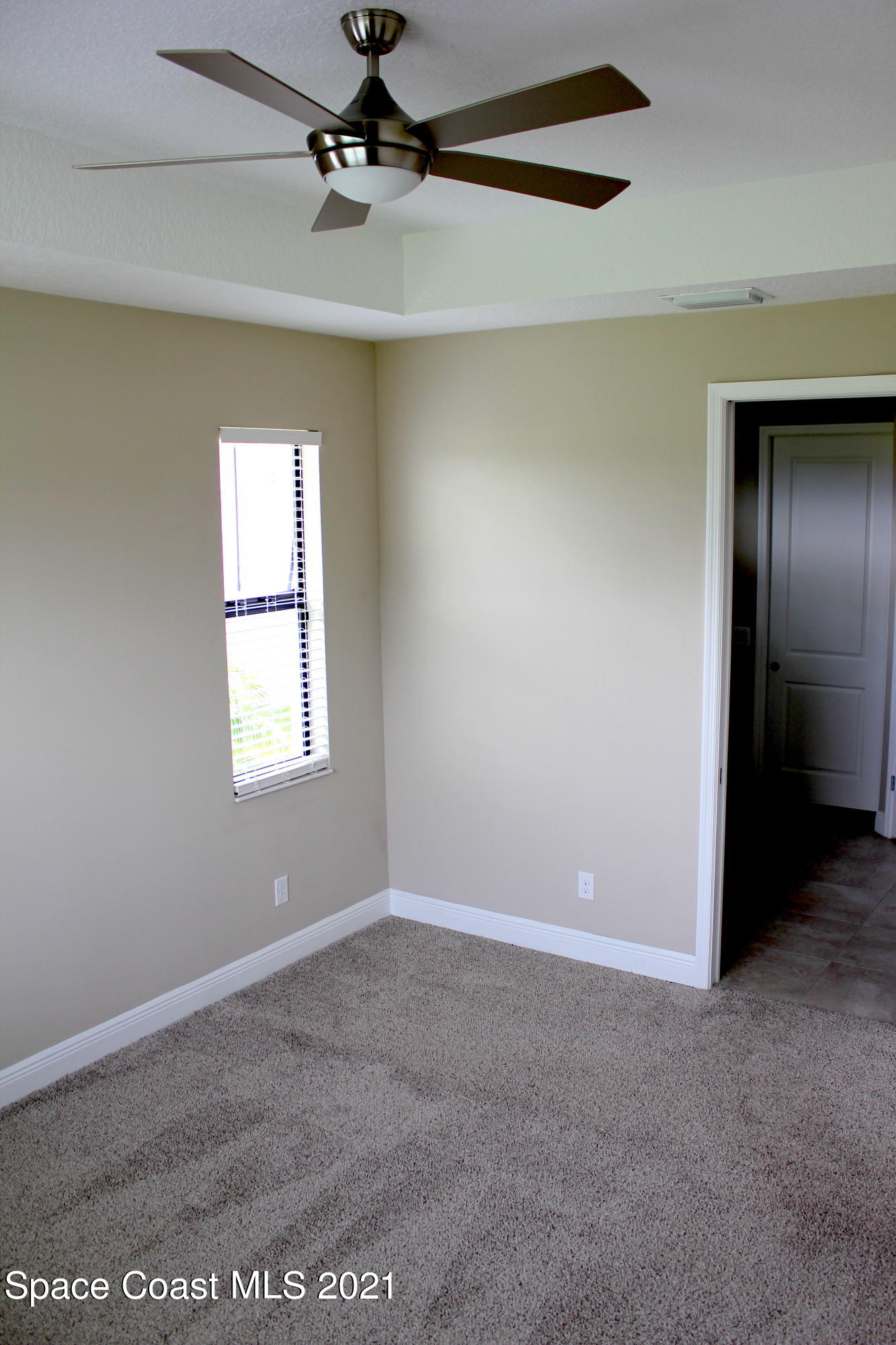3630 Stabane Place Melbourne, FL 32940 - Photo 6 of 24 an empty room with windows and fan