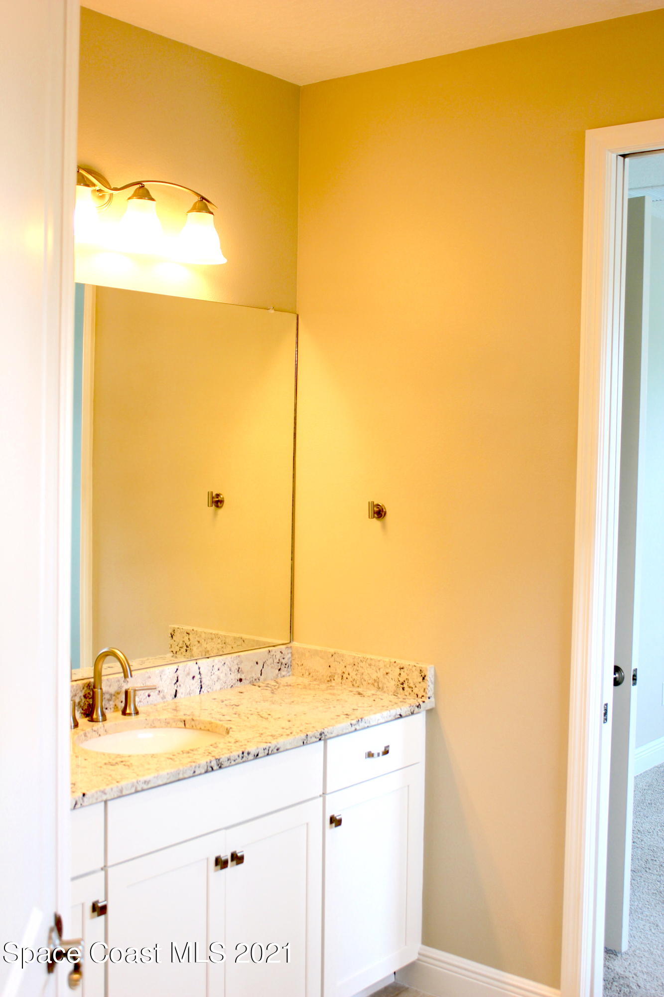 3630 Stabane Place Melbourne, FL 32940 - Photo 7 of 24 a bathroom with a granite countertop sink and a mirror
