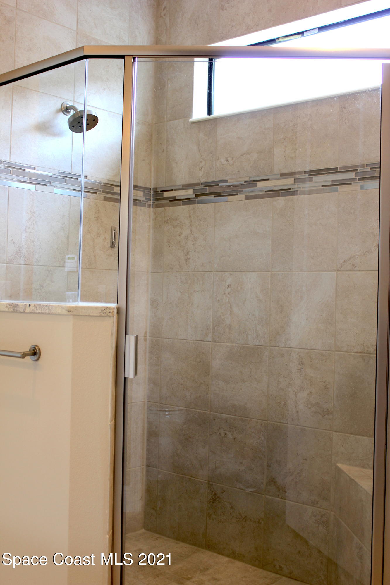 3630 Stabane Place Melbourne, FL 32940 - Photo 9 of 24 a bathroom with a glass shower door