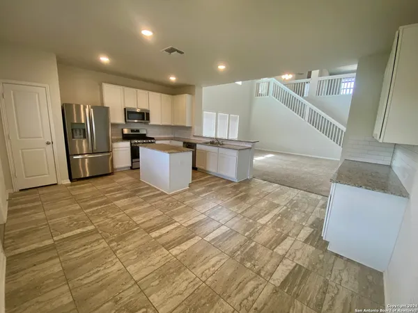 a view of kitchen with cabinets