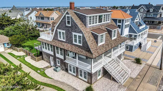 a view of a dining room with furniture a chandelier and wooden floor