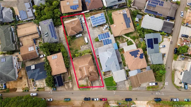 an aerial view of residential house with outdoor space and parking