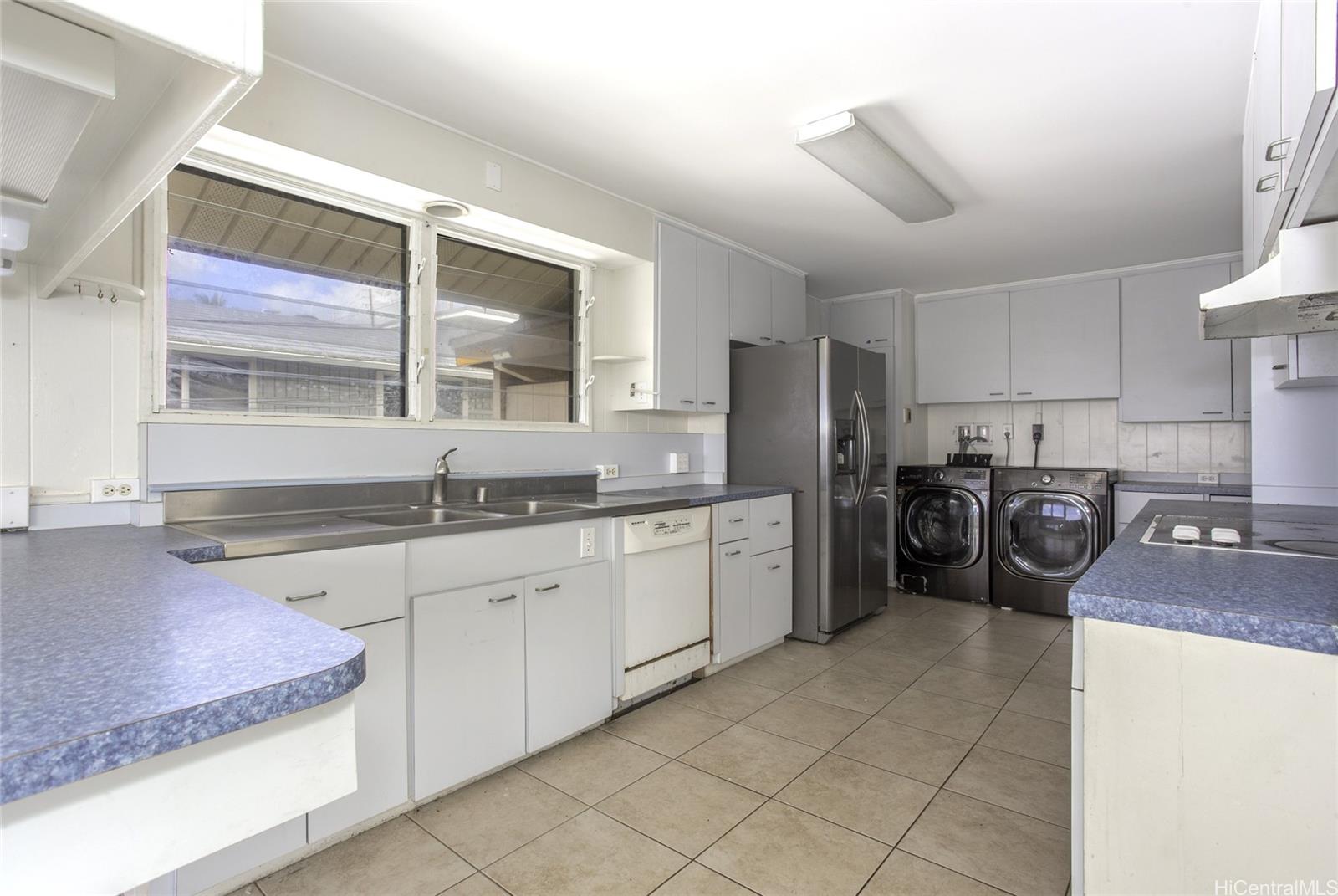 927 Lolena Street Honolulu, HI 96817 - Photo 6 of 12 a kitchen with sink refrigerator and cabinets
