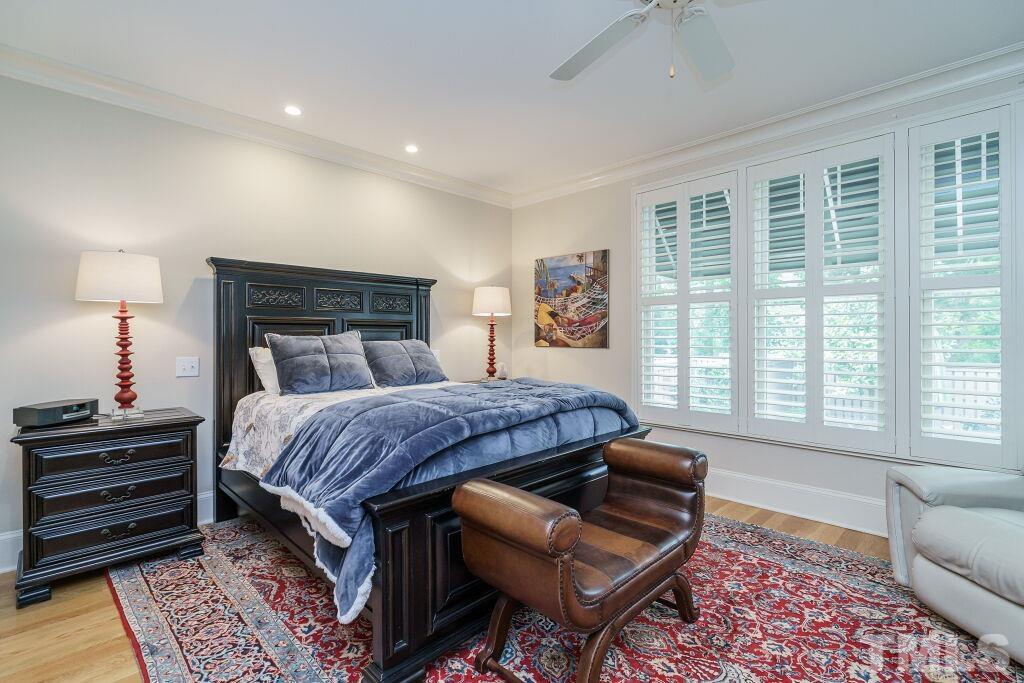 1833 Torrington Street Raleigh, NC 27615 - Photo 23 of 44 a bedroom with a bed and wooden floor