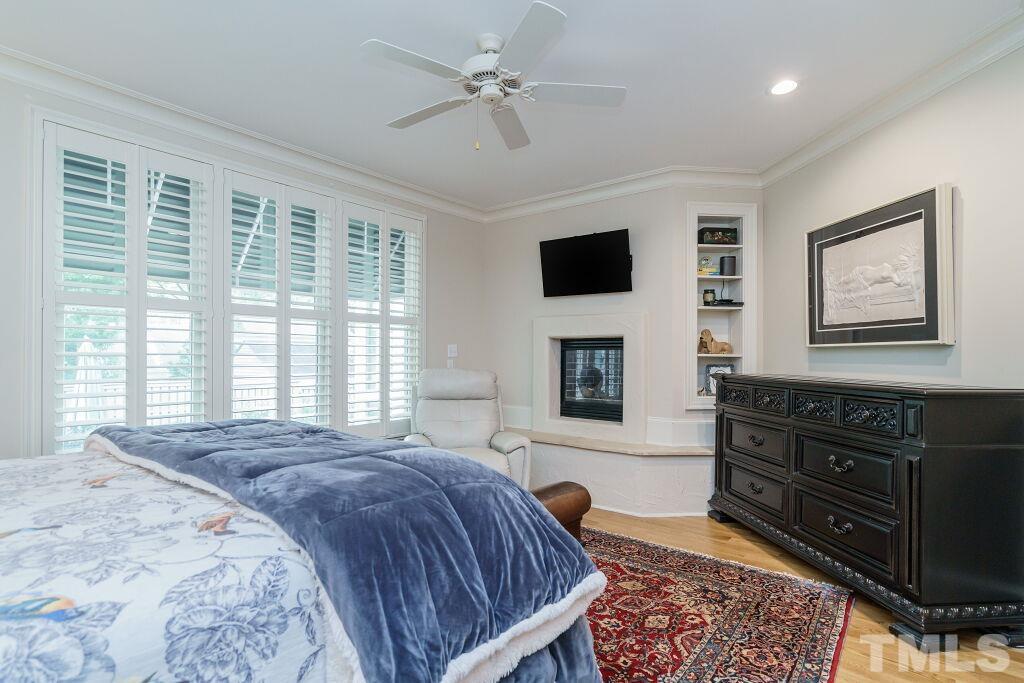 1833 Torrington Street Raleigh, NC 27615 - Photo 24 of 44 a spacious bedroom with a bed and a flat screen tv