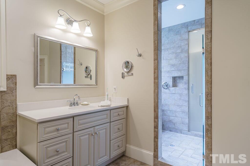 1833 Torrington Street Raleigh, NC 27615 - Photo 29 of 44 a bathroom with a double vanity sink and mirror