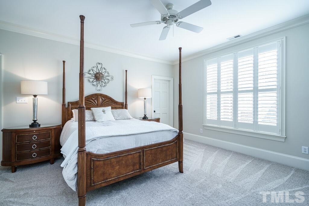 1833 Torrington Street Raleigh, NC 27615 - Photo 35 of 44 a bedroom with a bed a chandelier and a window