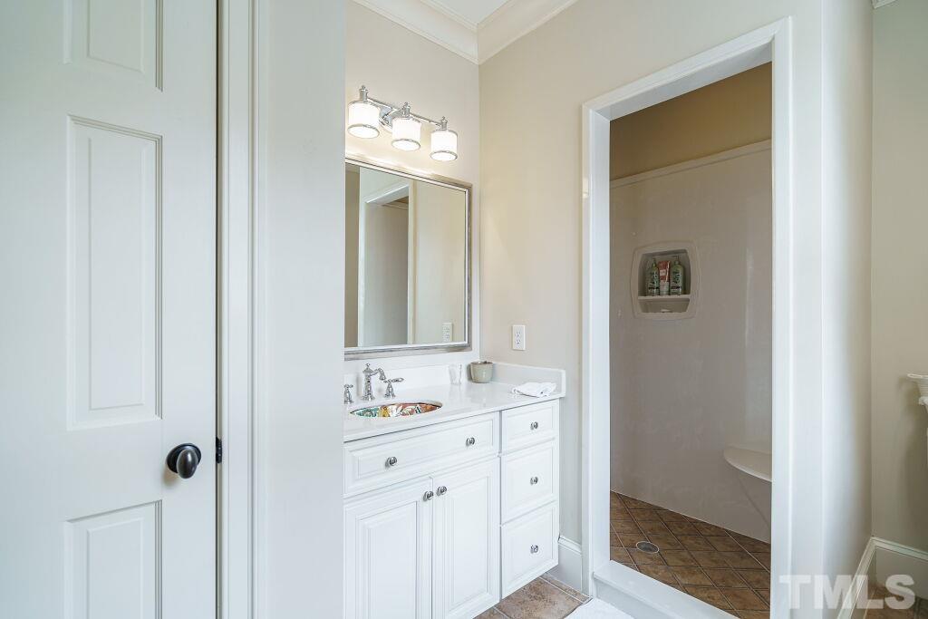 1833 Torrington Street Raleigh, NC 27615 - Photo 36 of 44 a bathroom with a mirror sink and vanity