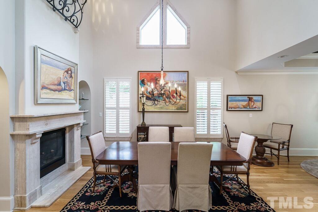 1833 Torrington Street Raleigh, NC 27615 - Photo 10 of 44 a dining room with furniture a fireplace and wooden floor