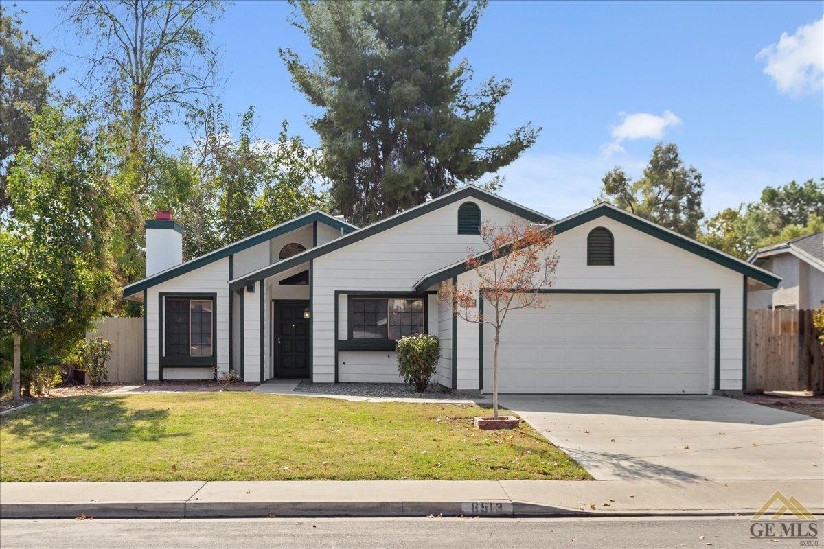 a view of a white house with a outdoor space and swimming pool