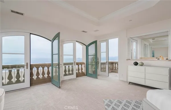 a spacious bedroom with a large bed and a large window