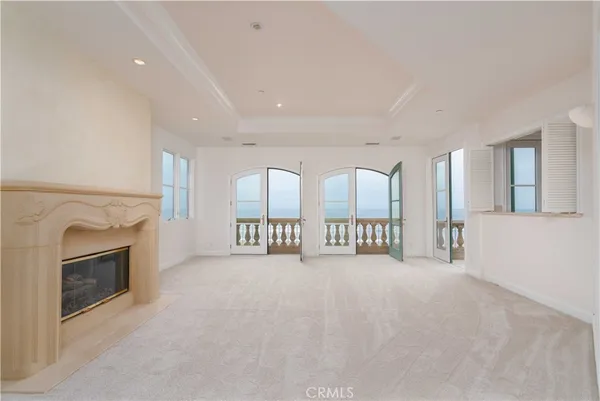 a view of an empty room with a fireplace and a window