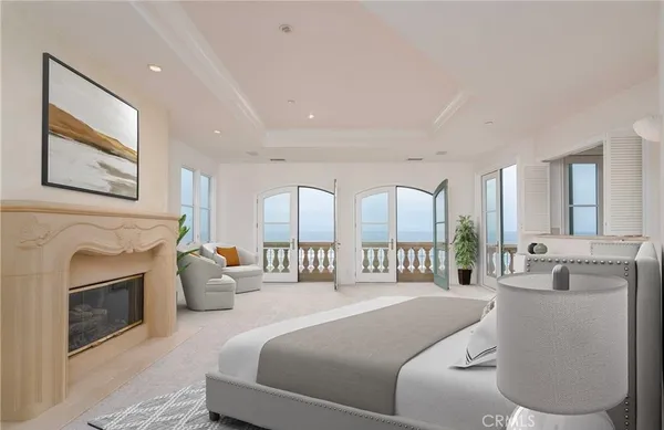a spacious bedroom with a balcony a bed and a fireplace