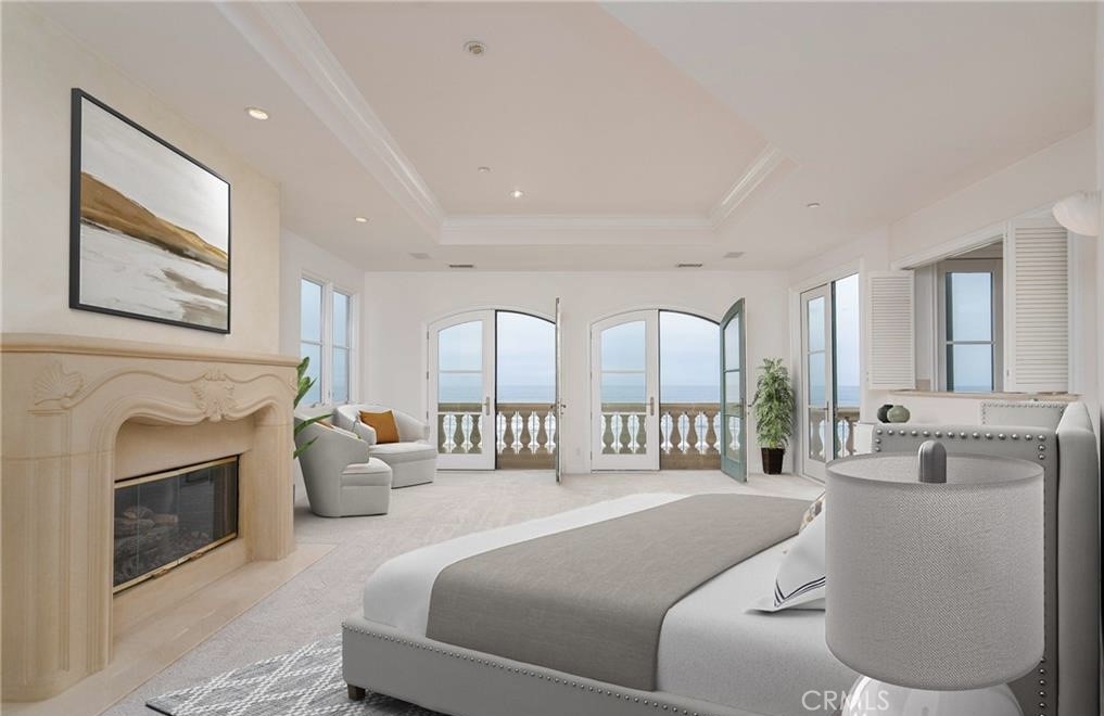 2420 The Strand Manhattan Beach, CA 90266 - Photo 20 of 42 a spacious bedroom with a balcony a bed and a fireplace