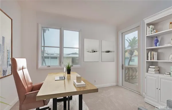 a view of a workspace with furniture and a potted plant