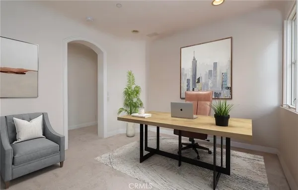 a living room with furniture and a potted plant