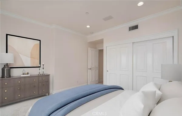 a bedroom with a bed and mirror