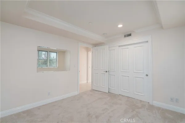 an empty room with windows and closet